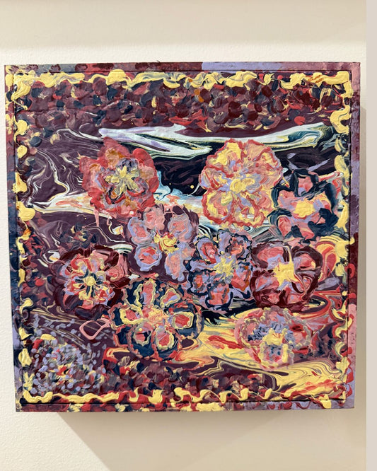 Abstract painting with vibrant colors on a beige wall