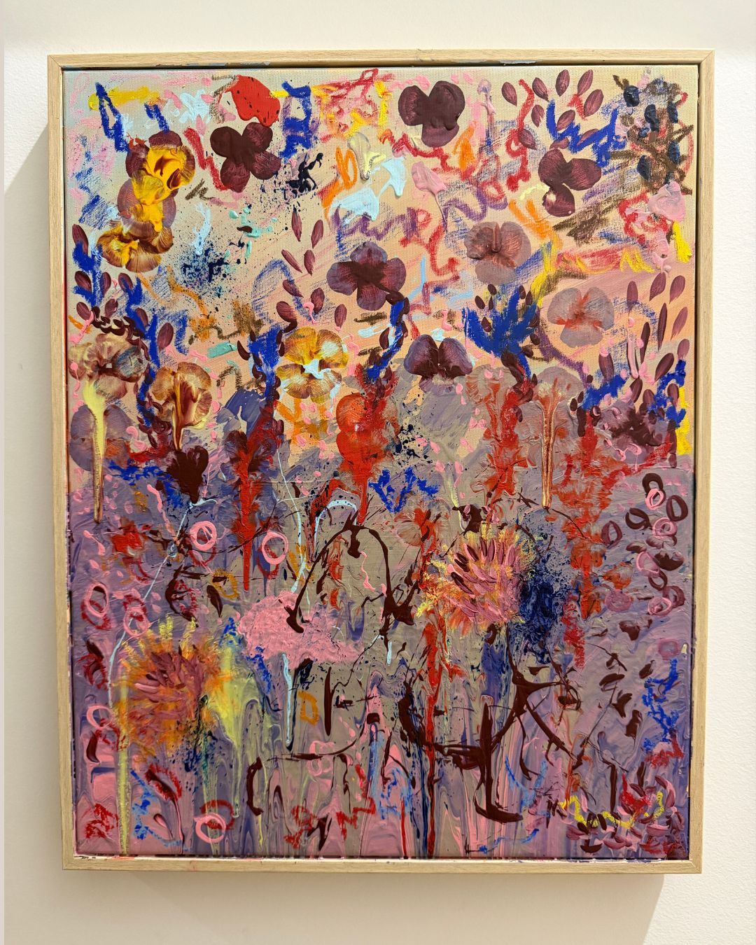 Abstract artwork with vibrant colors on a white wall