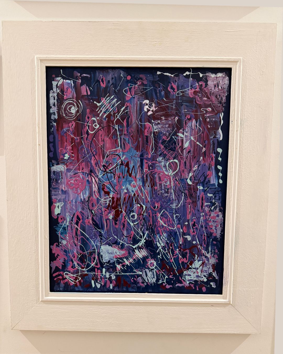 Abstract painting with purple and pink tones in a white frame.